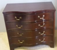 A Georgian style mahogany serpentine chest of drawers