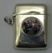 A silver vesta depicting a horse racing scene