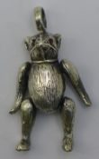 A silver teddy bear pendant