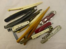 A quantity of vintage penknives, glove stretchers,