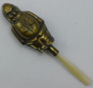 A brass rattle in the form of a policeman