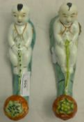 A pair of Chinese export porcelain wall hooks,