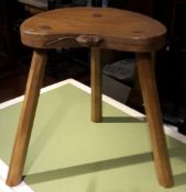 A three legged oak stool carved with a mouse