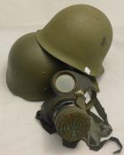 A gas mask and two helmets