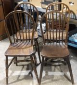 A set of six elm seated stick back kitchen chairs