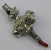 A coral mounted silver baby's rattle