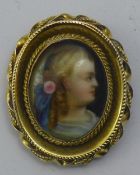 A Victorian 15 ct gold framed porcelain brooch with glass locket back