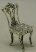 A silver miniature chair
