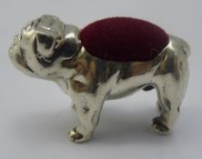 A silver pin cushion in the form of a bulldog