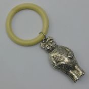 A silver teddy bear shaped rattle with makers mark of Charles Horner