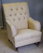 A large upholstered button back armchair