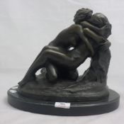 A bronze figure of lesbian lovers