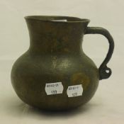A patinated bronze jug