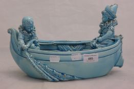 A Victorian blue glazed vase formed as two clowns in a boat