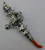 A silver and coral rattle