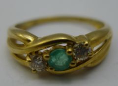 A 9 ct gold diamond and emerald ring