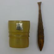 An olive wood needle case formed as a fish and a double ended egg cup