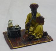 A cold painted bronze figure of a man smoking