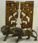 Two carved wooden lions together with two carved Eastern deities