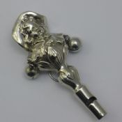 An Edwardian silver baby's rattle formed as a young girl