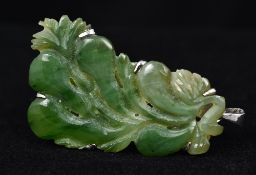 A 14K white gold and jade pendant/brooch Of pierced scrolling form. 4 cm high.