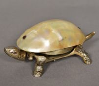 A late 19th/early 20th century table bell Formed as a tortoise with mother-of-pearl shell and wind