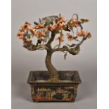 A Chinese hardstone mounted model of a bonsai tree Housed in a lacquered jardiniere. 23.5 cm wide.