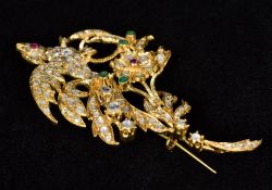 An 18 ct gold, diamond, emerald and ruby set brooch Formed as a phoenix perched on a branch. 7.