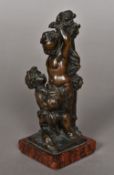 A 19th century patinated bronze figural group Formed as a putto helping a faun, tied to a tree,