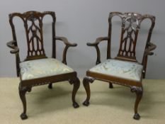 A pair of 19th century mahogany open armchairs The floral and scroll carved top rail above the