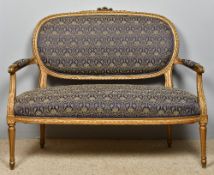 A Louis XV style upholstered gilt painted parlour settee The overstuffed oval back with ribbon tied