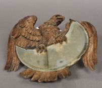 A 19th century Blackforest carved walnut wall glass Carved as an eagle clutching the bevelled