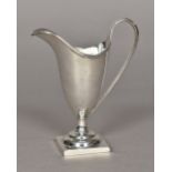 A George III silver cream jug, hallmarked London 1804,