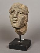 A carved stone head, possibly Romano British (100-300 AD) Found Holt, Cheshire, 1975,