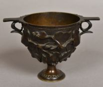 A 19th century patinated bronze twin handled urn With cast scrolling vine decorations. 18 cm wide.