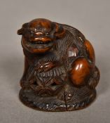 An 18th century carved dog-of-fo Of small proportions, with glass bead inset eyes,