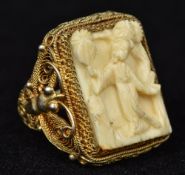 An early 20th century Chinese carved ivory set silver gilt ring Worked with the figure of a female.