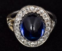 A white gold or platinum Art Deco diamond and cabochon sapphire ring The central cabochon sapphire