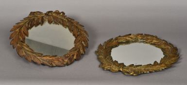 A pair of 19th century gilt bronze wall glasses Each formed as a laurel wreath. Each 40 cm wide.