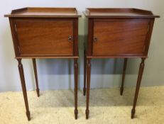 A pair of 19th century style mahogany bedside cupboards Each with three quarter galleried top above