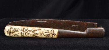 A 19th century bone handled folding knife The handle decorated with a bird amongst floral sprays,