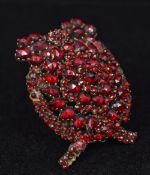 A 19th century unmarked white metal garnet set pendant brooch Of domed form. 4 cm high.