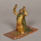 An Austrian cold painted bronze figure Modelled as an Arab gentleman praying, marked for Bergmann.