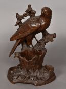 A 19th century Blackforest carved bird of prey Modelled with glass inset eyes,