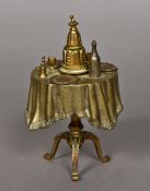 A Victorian bronze table bell Formed as a set dining table. 14 cm high.