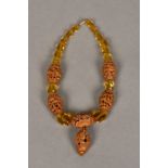 A Chinese carved nut and faceted bead necklace Set with five carved nut beads,