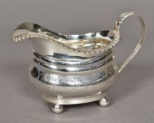 A George III silver cream jug, hallmarked London 1817,