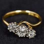 An 18 ct gold diamond set three stone ring The central stone approximately 0.5 carats.