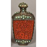 A white metal turquoise set red cinnabar lacquer panelled snuff bottle and stopper Each panel