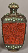 A white metal turquoise set red cinnabar lacquer panelled snuff bottle and stopper Each panel